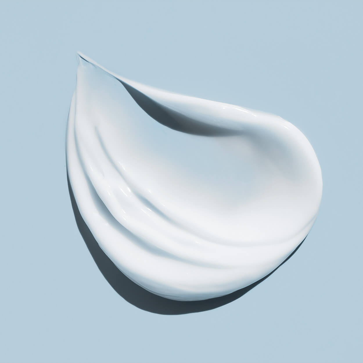 The texture of a Byrokko after-sun cream, in travel size.